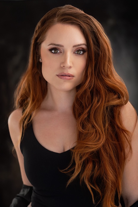 Headshot of Katelynn with a dramatic expression in a black top
