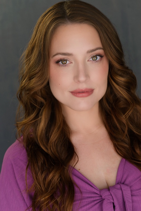 Headshot of Katelynn in a purple knotted top, close crop